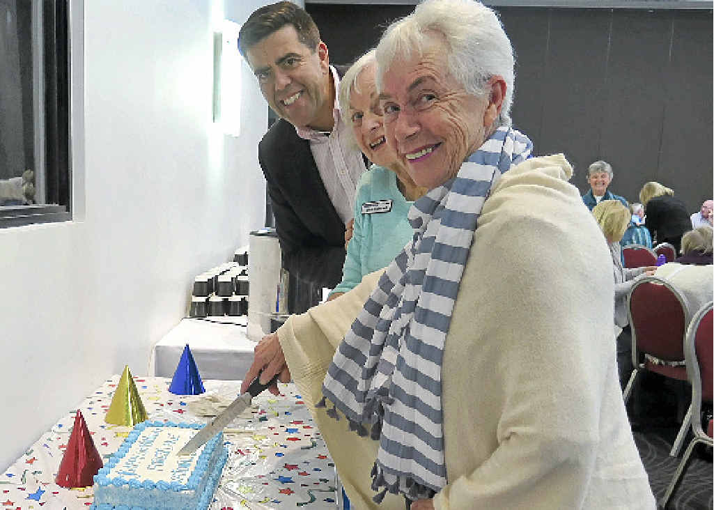 Members celebrate with a fourth birthday cake. Members celebrate with a fourth birthday cake.